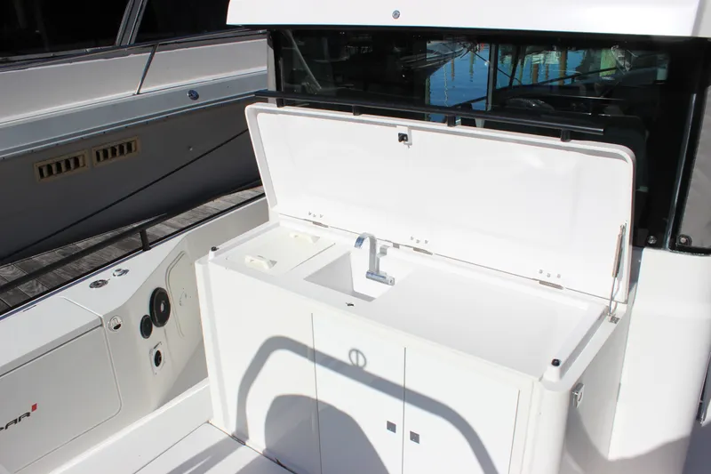 Slide: The Image of 2019 Axopar Brabus 28 Cabin boat sink area with open lid and faucet. - 12