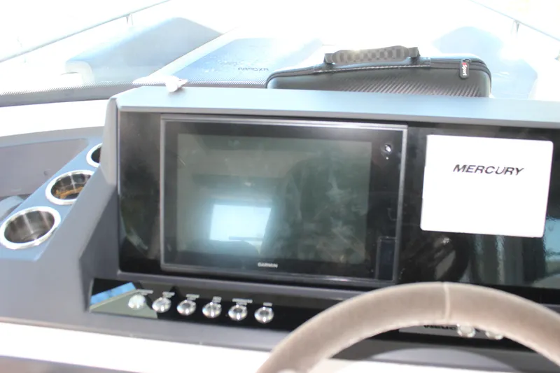 Slide: The Image of Dashboard of 2019 Axopar Brabus 28 Cabin with Garmin display and Mercury label. - 16