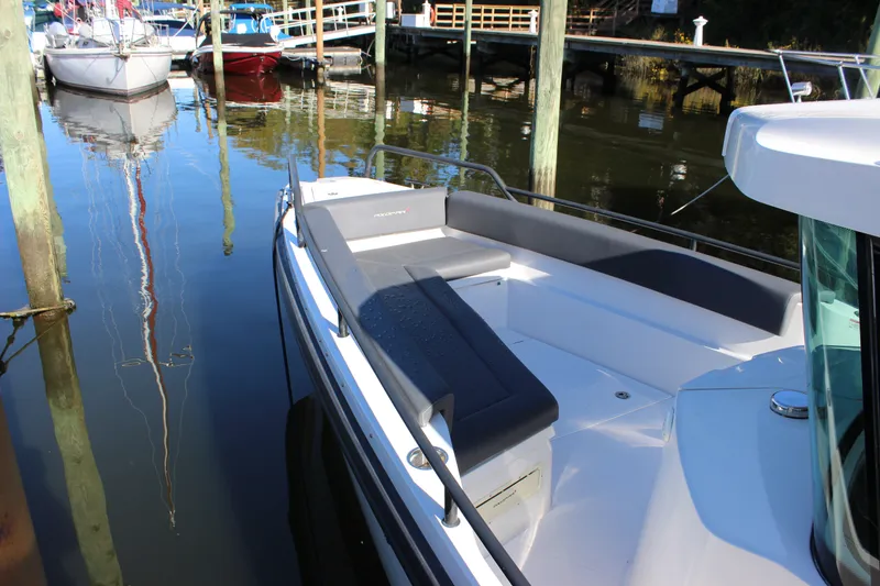 Slide: The Image of 2019 Axopar Brabus 28 Cabin boat docked, featuring sleek seating and modern design. - 8