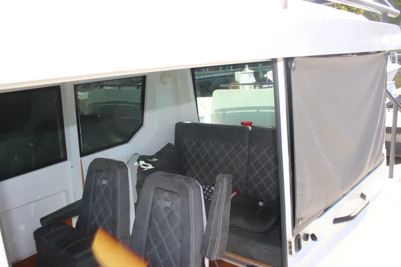 Slide: The Image of Interior view of 2019 Axopar Brabus 28 Cabin with seating and windows. - 9