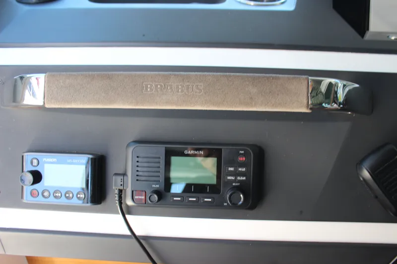 Slide: The Image of Control panel of 2019 Axopar Brabus 28 Cabin with Garmin and Fusion devices. - 18