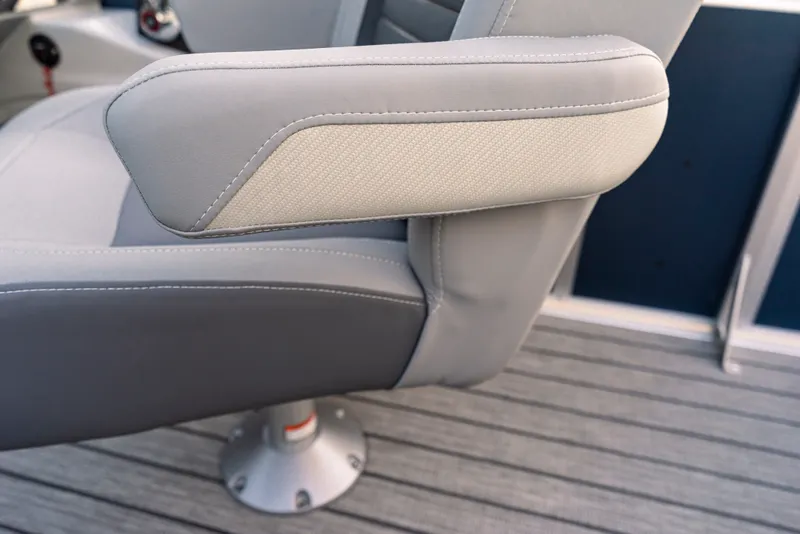Slide: The Image of Close-up of a gray boat seat with armrest on a striped floor. - 33