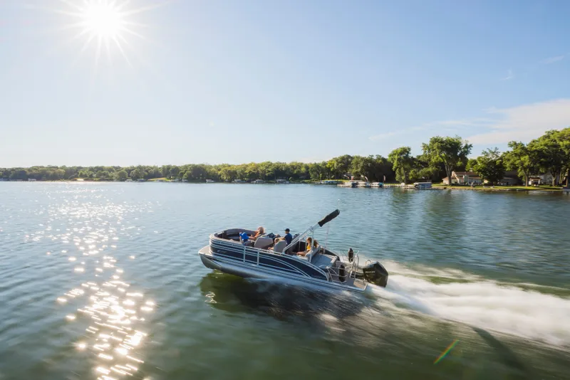 Slide: The Image of A Harris Solstice 230 pontoon boat speeds across a sunny lake. - 16