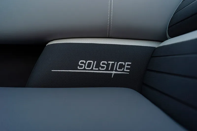 Slide: The Image of Close-up of seat with "Solstice" embroidery on dark upholstery. - 40