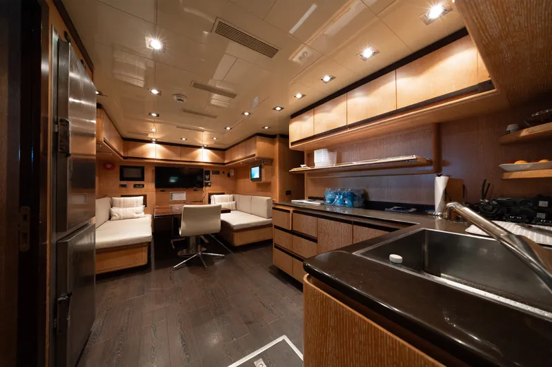 Slide: The Image of Luxurious interior of 2009 Mangusta 165 yacht with modern kitchen and seating area. - 62