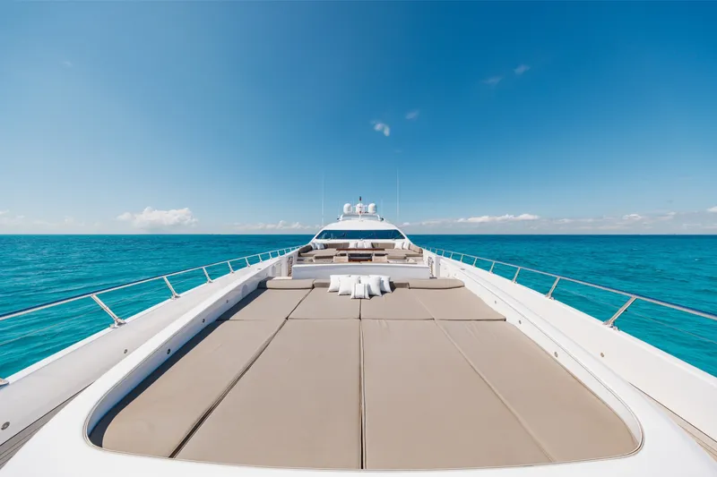 Slide: The Image of Luxurious 2009 Mangusta 165 yacht deck with sunbeds, surrounded by clear blue ocean. - 56