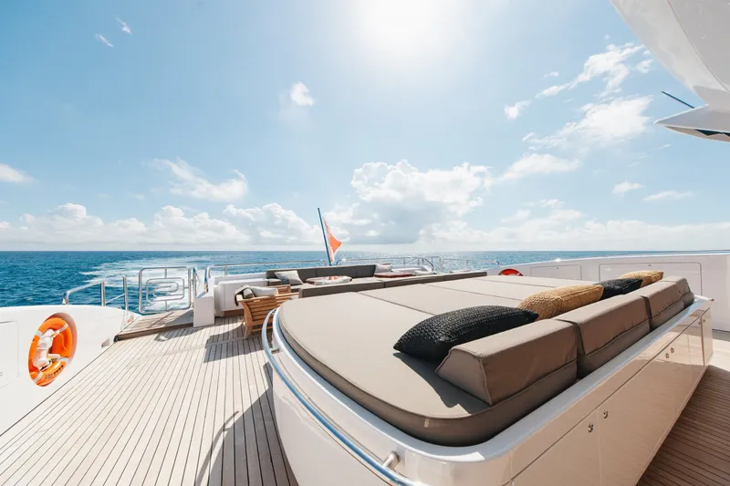 Slide: The Image of Luxurious 2009 Mangusta 165 yacht deck with sun loungers and ocean view. - 15