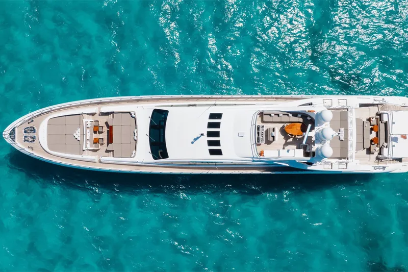 Slide: The Image of Aerial view of 2009 Mangusta 165 yacht on turquoise water. - 52