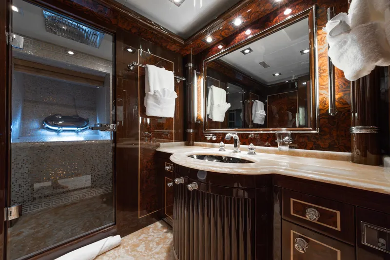 Slide: The Image of Luxurious bathroom interior on 2009 Mangusta 165 yacht, featuring elegant fixtures and rich wood finishes. - 39