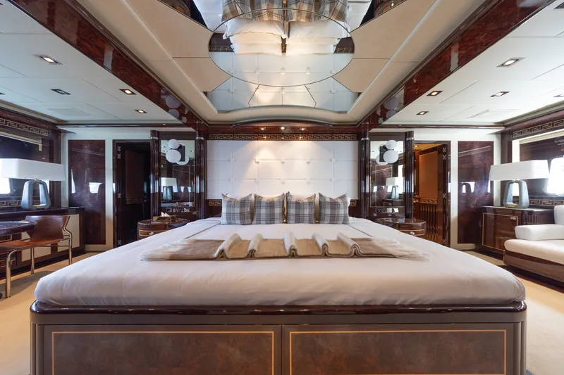 Slide: The Image of Luxurious bedroom interior on 2009 Mangusta 165 yacht, featuring elegant decor and plush bedding. - 26