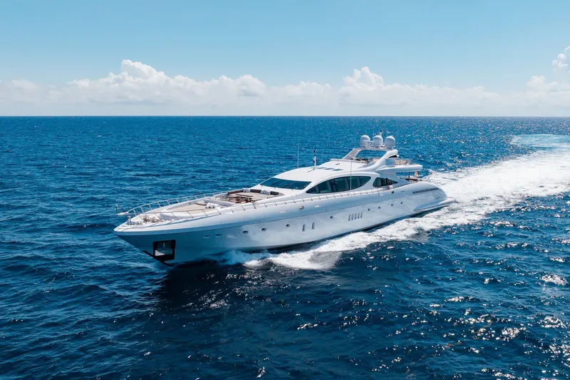 Slide: The Image of Luxurious 2009 Mangusta 165 yacht cruising on open blue sea under clear sky. - 7
