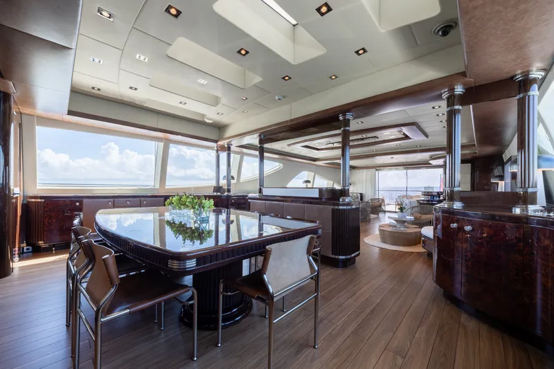Slide: The Image of Luxurious interior of 2009 Mangusta 165 yacht with elegant dining area and panoramic windows. - 24