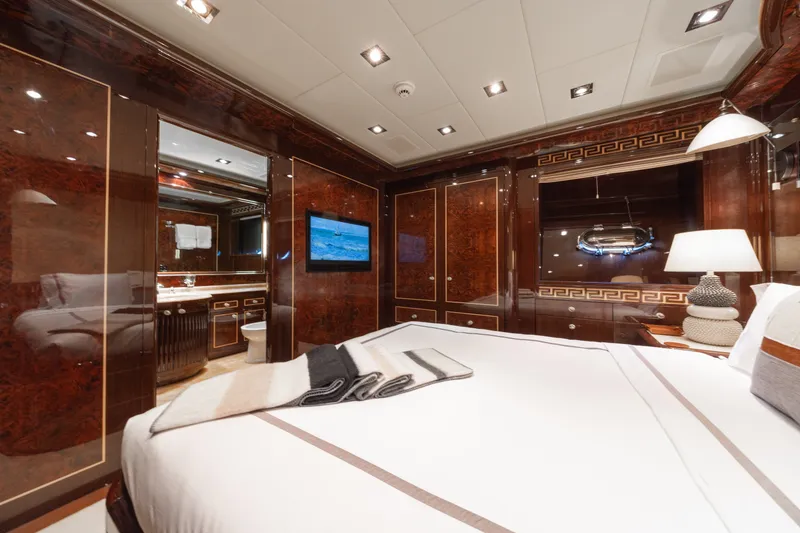 Slide: The Image of Luxurious bedroom interior of 2009 Mangusta 165 yacht with elegant wood paneling and modern amenities. - 47
