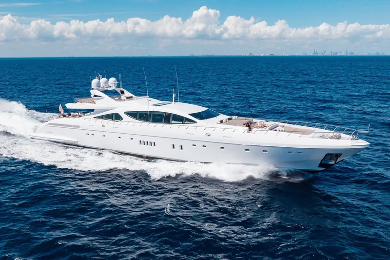 The Image of Luxurious 2009 Mangusta 165 yacht cruising on open sea under clear skies. - 0