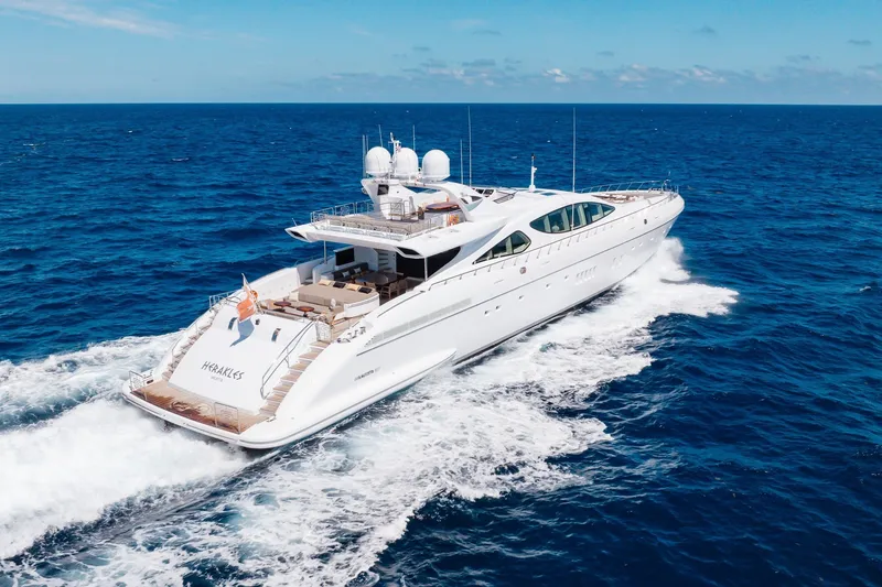 Slide: The Image of Luxurious 2009 Mangusta 165 yacht cruising on open sea under clear skies. - 5