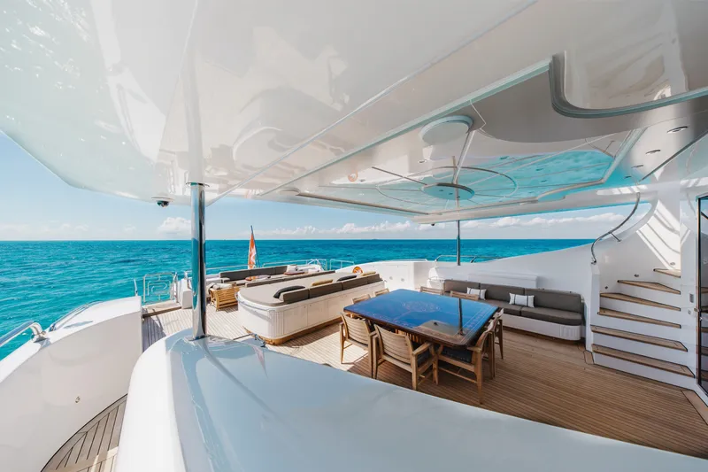 Slide: The Image of Luxurious 2009 Mangusta 165 yacht deck with elegant seating and ocean view. - 13