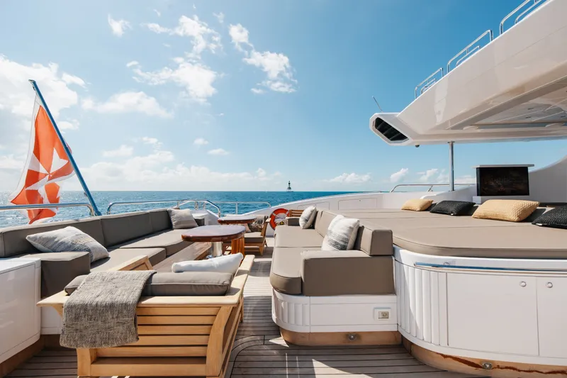 Slide: The Image of Luxurious 2009 Mangusta 165 yacht deck with plush seating and ocean view. - 11