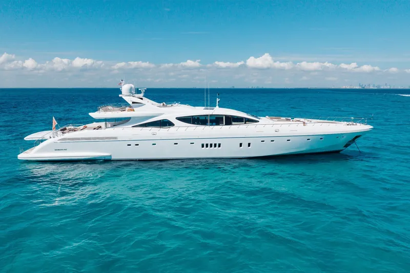 Slide: The Image of Luxurious 2009 Mangusta 165 yacht cruising on clear blue ocean waters. - 3