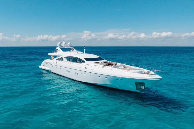 Slide: The Image of Luxurious 2009 Mangusta 165 yacht cruising on clear blue ocean waters. - 4