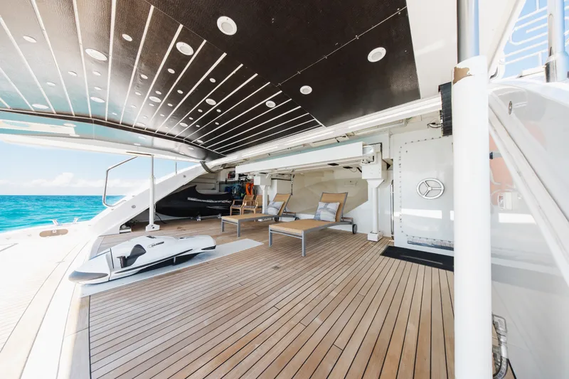 Slide: The Image of Luxurious 2009 Mangusta 165 yacht deck with sun loungers and ocean view. - 61