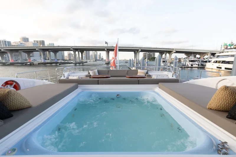 Slide: The Image of Luxurious 2009 Mangusta 165 yacht with jacuzzi, city skyline, and bridge view. - 14