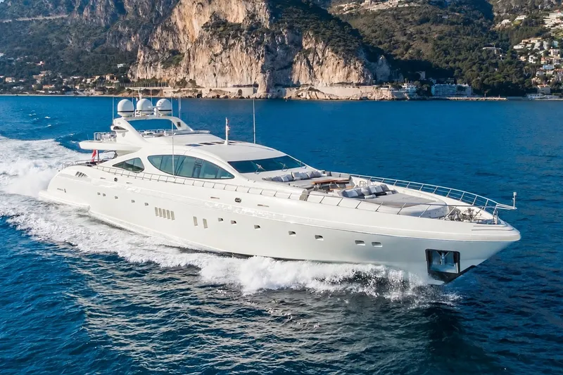 The Image of Luxurious 2009 Mangusta 165 yacht cruising in scenic coastal waters. - 1