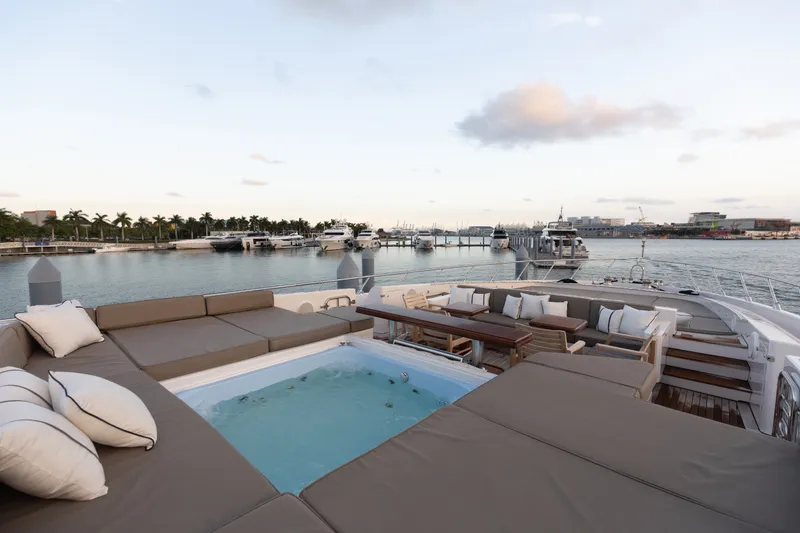 Slide: The Image of Luxurious 2009 Mangusta 165 yacht deck with jacuzzi and seating, docked at marina. - 58