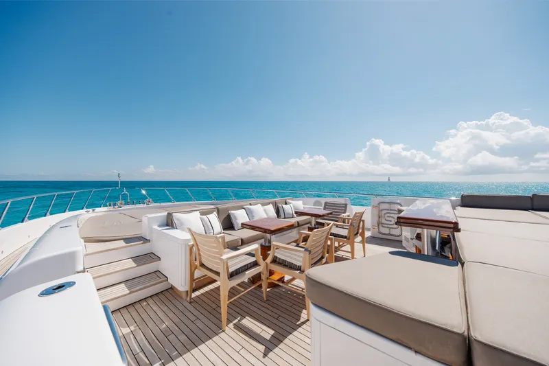 Slide: The Image of Luxurious 2009 Mangusta 165 yacht deck with elegant seating, overlooking serene ocean views. - 54