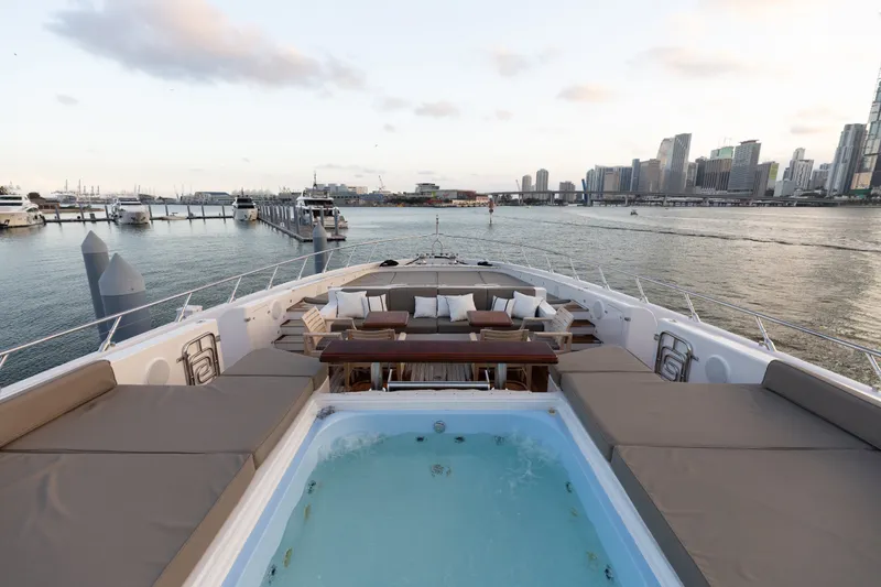 Slide: The Image of Luxurious 2009 Mangusta 165 yacht with jacuzzi, overlooking city skyline and marina. - 55