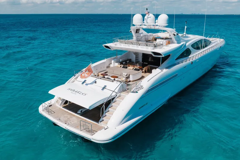 Slide: The Image of Luxurious 2009 Mangusta 165 yacht cruising on clear blue ocean waters. - 2