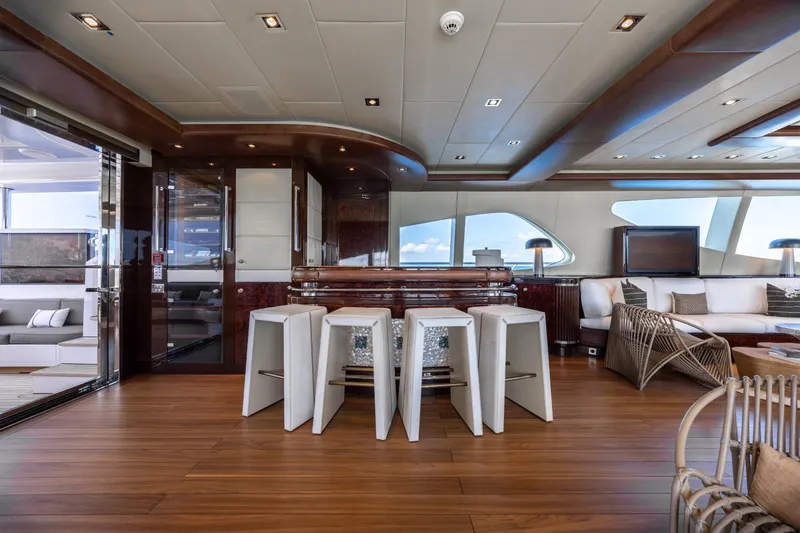 Slide: The Image of Luxurious interior of 2009 Mangusta 165 yacht with modern seating and elegant wood finishes. - 21