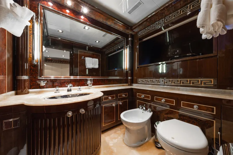 Slide: The Image of Luxurious bathroom interior on 2009 Mangusta 165 yacht, featuring elegant wood and marble finishes. - 48