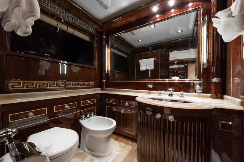 Slide: The Image of Luxurious bathroom interior on 2009 Mangusta 165 yacht, featuring elegant wood finishes and marble accents. - 46