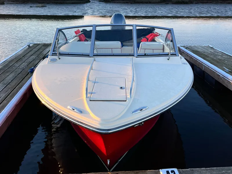 Slide: The Image of A 2020 Rossiter 20 boat docked. It features a red hull and white deck area. - 3