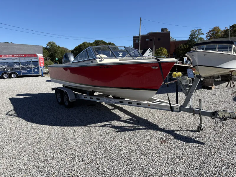 Slide: The Image of A red 2020 Rossiter 20 boat is on a trailer in a gravel lot. - 7