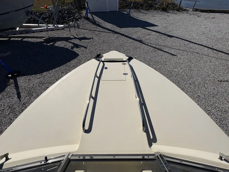 Slide: The Image of The image shows the bow deck of a 2020 Rossiter 20 boat on a gravel lot. - 32