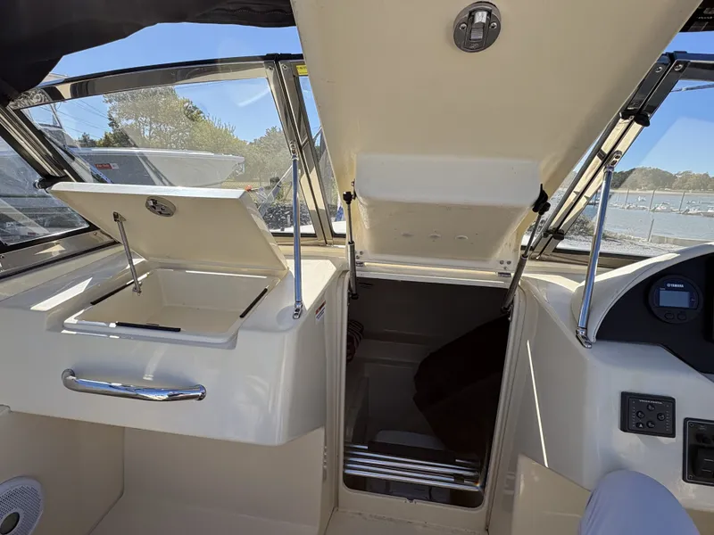 Slide: The Image of Interior view of a 2020 Rossiter 20 boat with storage compartments and a helm console. - 28
