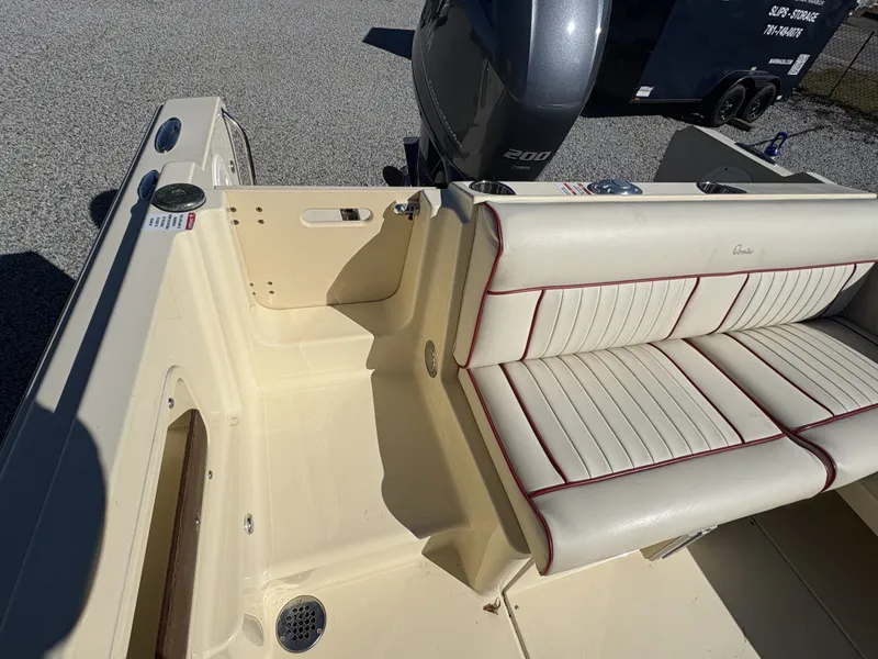 Slide: The Image of The image shows the cockpit of a 2020 Rossiter 20 boat with cream-colored seating. - 18