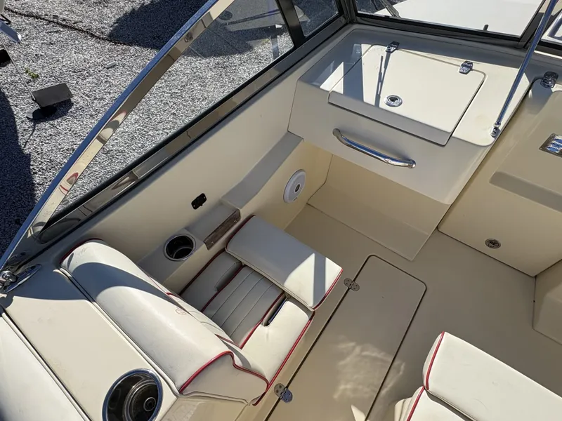 Slide: The Image of The image shows the cockpit of a 2020 Rossiter 20 boat with beige upholstery and red accents. - 23