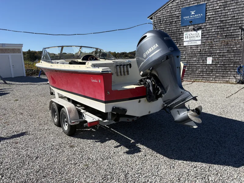 Slide: The Image of A red 2020 Rossiter 20 boat on a trailer with a Yamaha outboard motor. - 10
