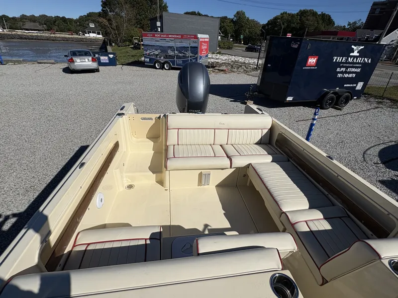 Slide: The Image of The image shows the cockpit of a 2020 Rossiter 20 boat with cream-colored upholstery. - 16