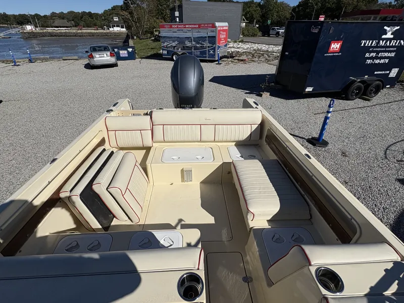 Slide: The Image of The image shows the cockpit of a 2020 Rossiter 20 boat with beige upholstery. - 19