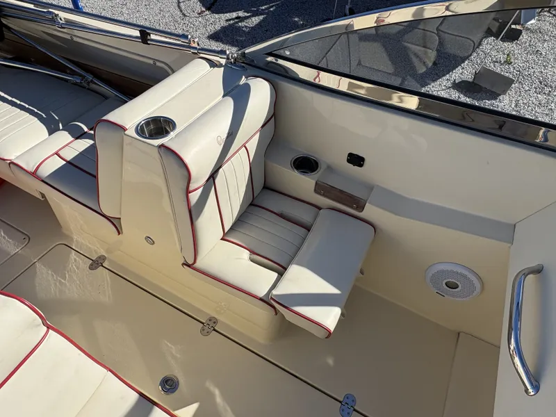 Slide: The Image of The image shows the cockpit of a 2020 Rossiter 20 boat with cream seats and red stitching. - 22
