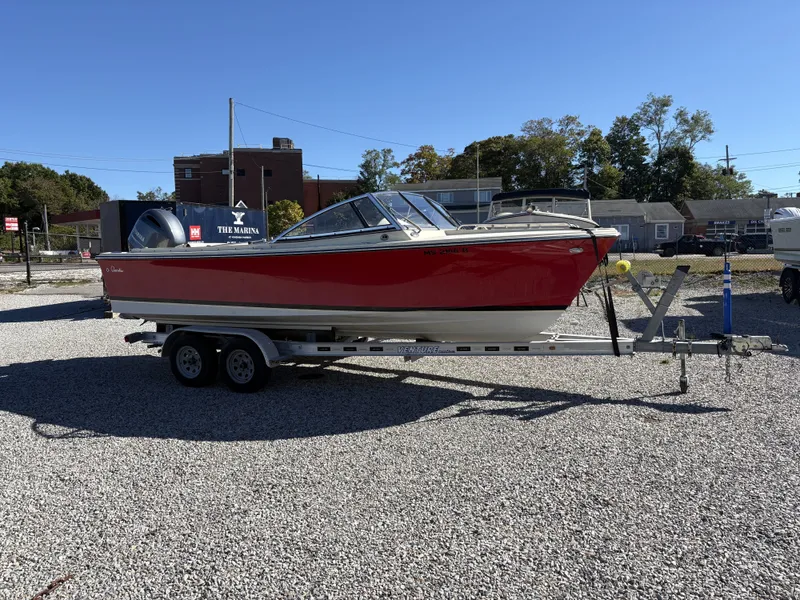 Slide: The Image of A red 2020 Rossiter 20 boat on a trailer in a gravel lot. - 6
