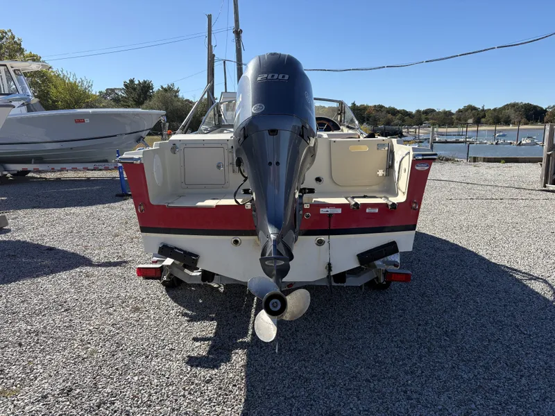 Slide: The Image of Rear view of a 2020 Rossiter 20 boat with an outboard motor. - 11