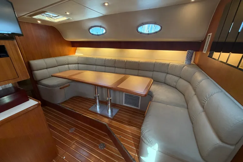 Slide: The Image of Luxurious interior of 1998 Tiara Yachts 4000 Express with plush seating and wooden accents. - 17