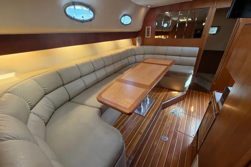 Slide: The Image of Luxurious interior of a 1998 Tiara Yachts 4000 Express with plush seating and wooden accents. - 18