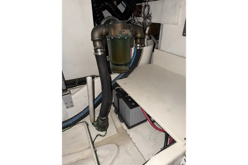 Slide: The Image of Engine compartment of 1998 Tiara Yachts 4000 Express with visible battery and hoses. - 34
