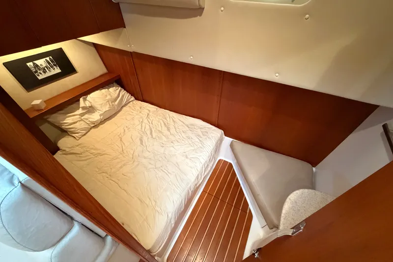 Slide: The Image of 1998 Tiara Yachts 4000 Express cabin with cozy bed and wooden interior. - 20