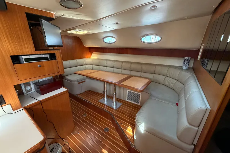 Slide: The Image of Interior of 1998 Tiara Yachts 4000 Express with wood accents and plush seating. - 16